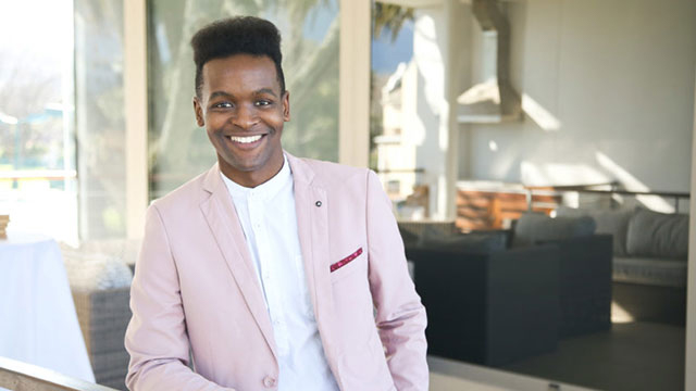 Student Tshepo Moloko smiles in a well-lit room